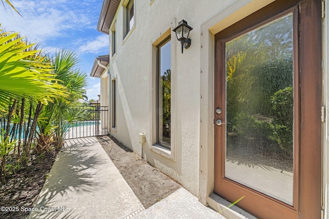 entrance to property with stucco siding