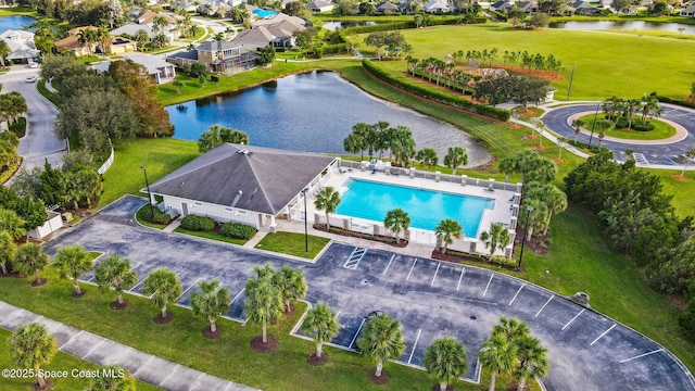drone / aerial view featuring a water view and a residential view