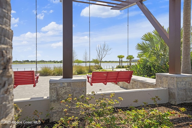 view of patio with a water view