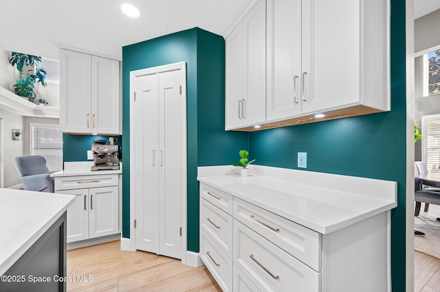 kitchen with recessed lighting, light wood-type flooring, and white cabinets