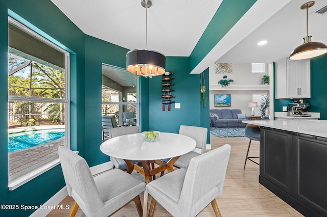 dining room featuring an inviting chandelier, baseboards, light wood-style floors, and recessed lighting