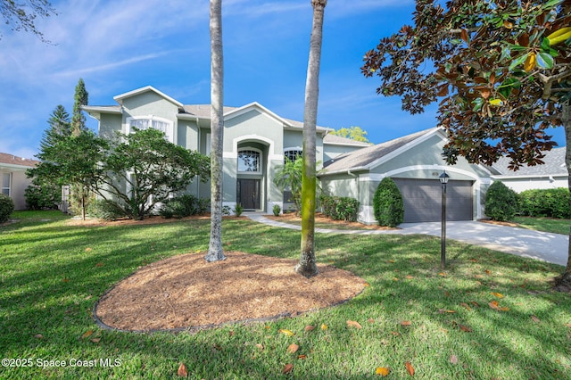 view of front of property featuring a front yard, driveway, an attached garage, and stucco siding