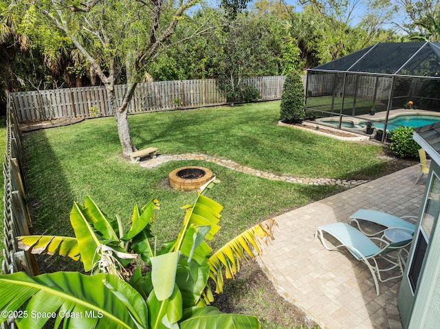 view of yard featuring a fire pit, a fenced in pool, a patio, glass enclosure, and a fenced backyard