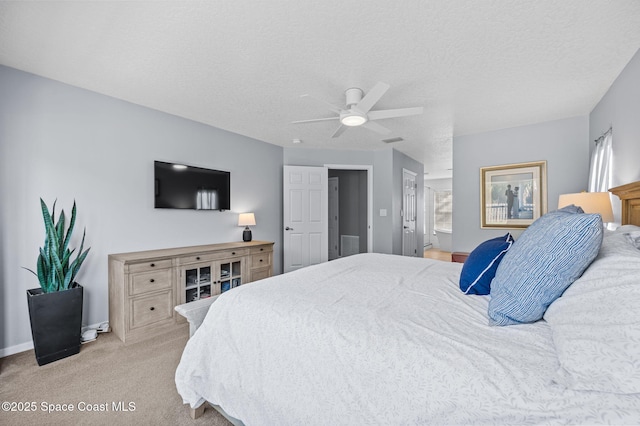 bedroom featuring carpet floors, visible vents, ceiling fan, a textured ceiling, and baseboards