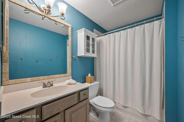 bathroom with a textured ceiling, vanity, tile patterned flooring, and toilet