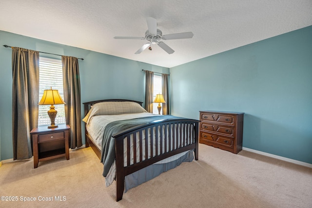 bedroom featuring carpet floors, multiple windows, a ceiling fan, and baseboards