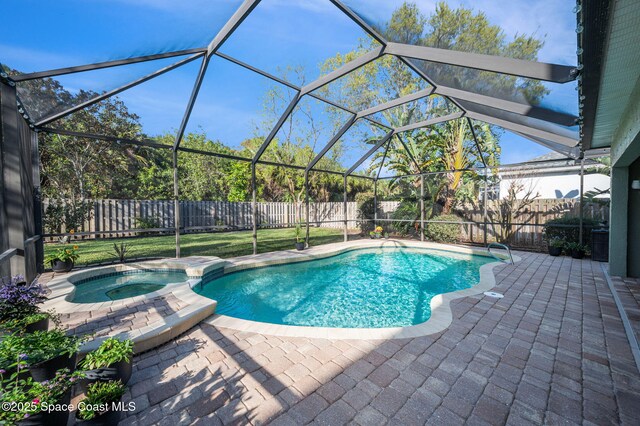 view of pool with a patio, a fenced backyard, a pool with connected hot tub, and a lanai