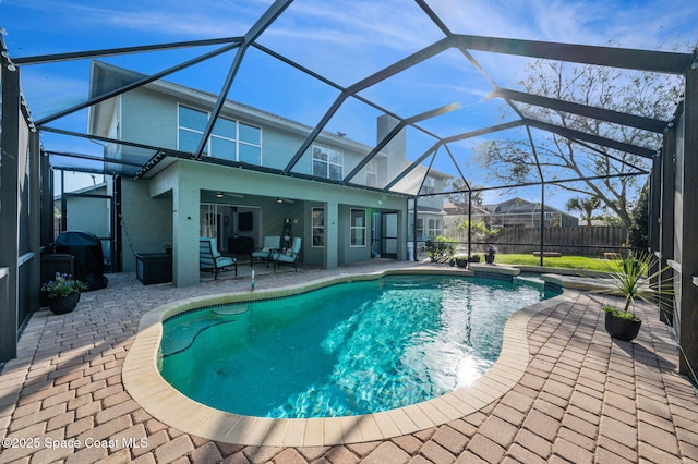 view of swimming pool featuring a fenced in pool, a ceiling fan, a patio, glass enclosure, and fence