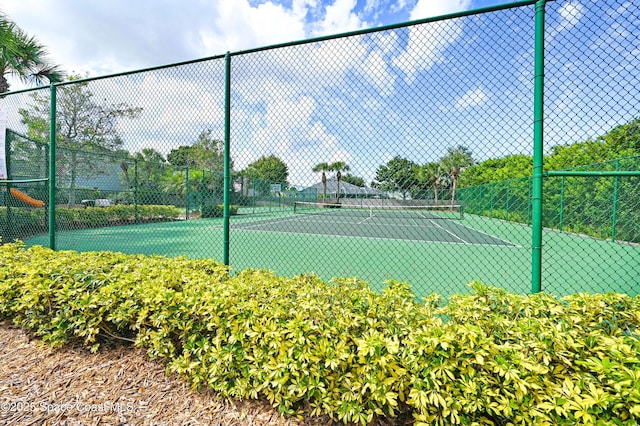 view of sport court with fence