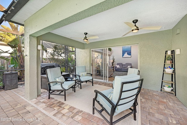 view of patio / terrace featuring outdoor lounge area, a lanai, and a ceiling fan