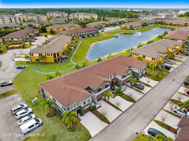 drone / aerial view featuring a residential view and a water view