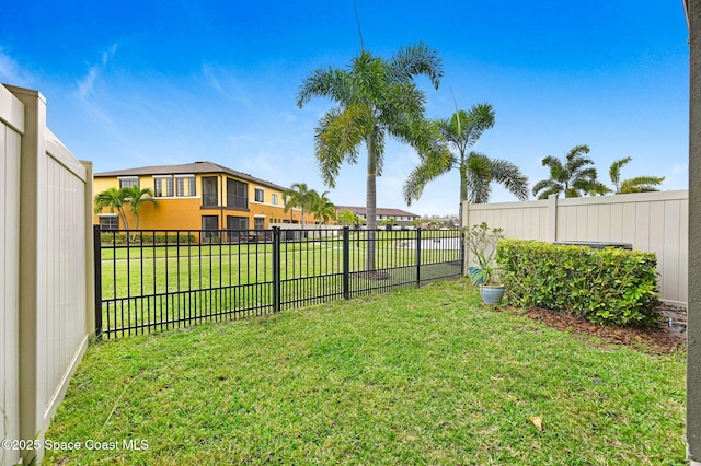 view of yard with a fenced backyard and a residential view