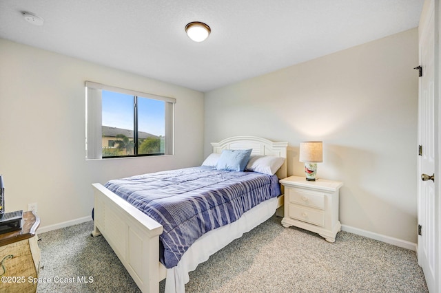 bedroom with light carpet and baseboards