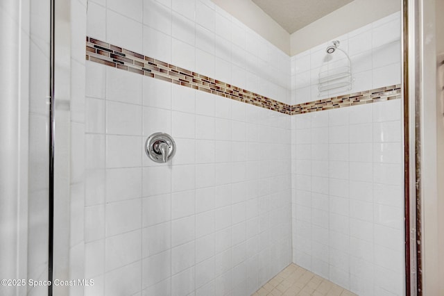 full bath with a tile shower