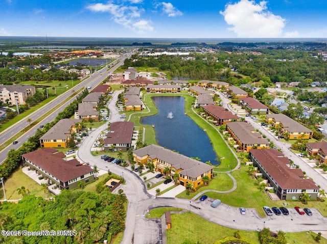 birds eye view of property with a water view and a residential view