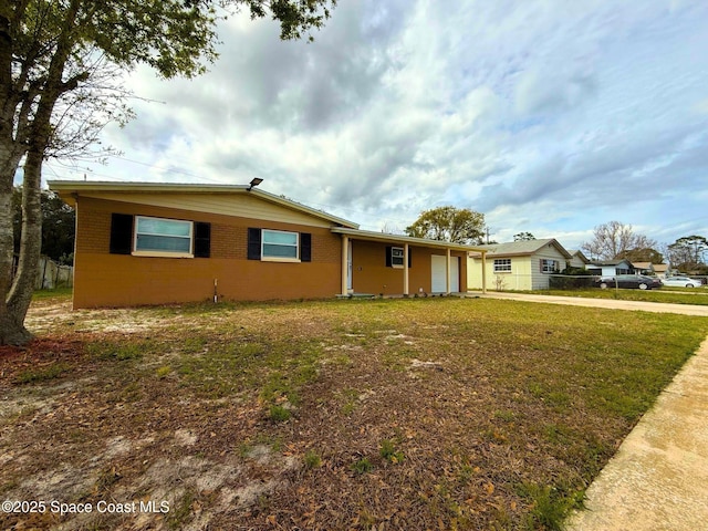 single story home with an attached garage, fence, concrete driveway, and a front yard