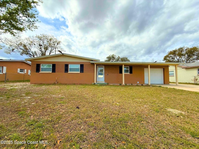 single story home featuring concrete driveway, brick siding, an attached garage, and a front yard