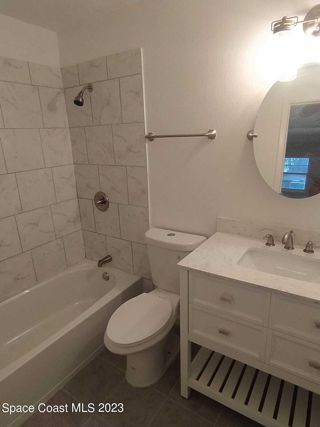 bathroom with toilet, tile patterned flooring,  shower combination, and vanity