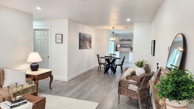 1151 Covina St, Cocoa, FL 32927 - living area with light wood-style floors, recessed lighting, plenty of natural light, baseboards, and a chandelier