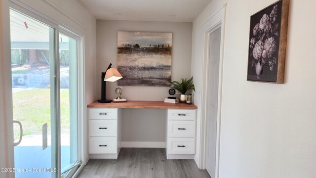 1151 Covina St, Cocoa, FL 32927 - doorway to outside featuring light wood finished floors and baseboards