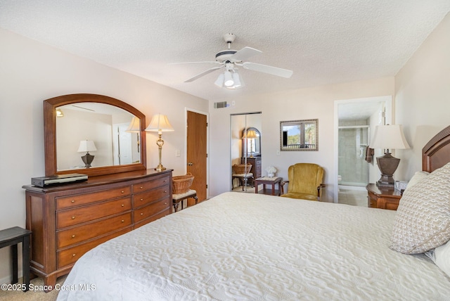 bedroom featuring a textured ceiling, ceiling fan, a closet, and visible vents