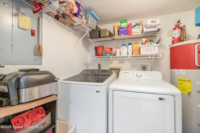 clothes washing area with a textured ceiling, electric water heater, laundry area, electric panel, and washing machine and clothes dryer