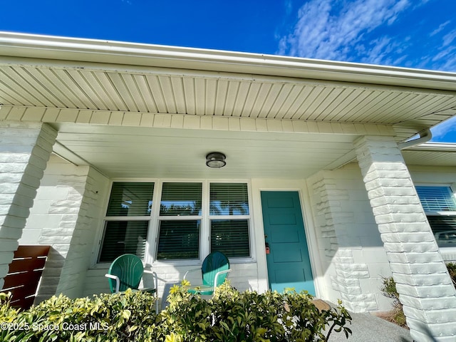 view of exterior entry featuring a porch