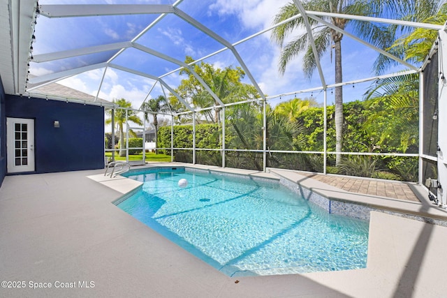 outdoor pool with a patio and a lanai