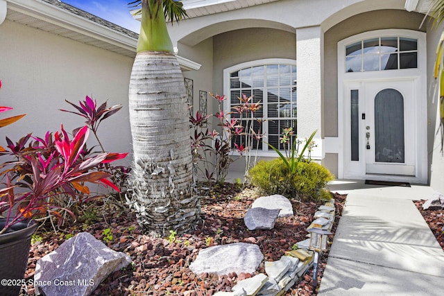 property entrance featuring stucco siding