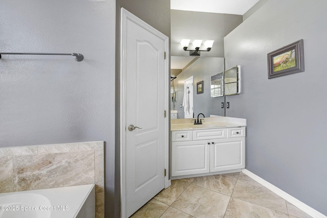bathroom with a tub to relax in, vanity, and baseboards