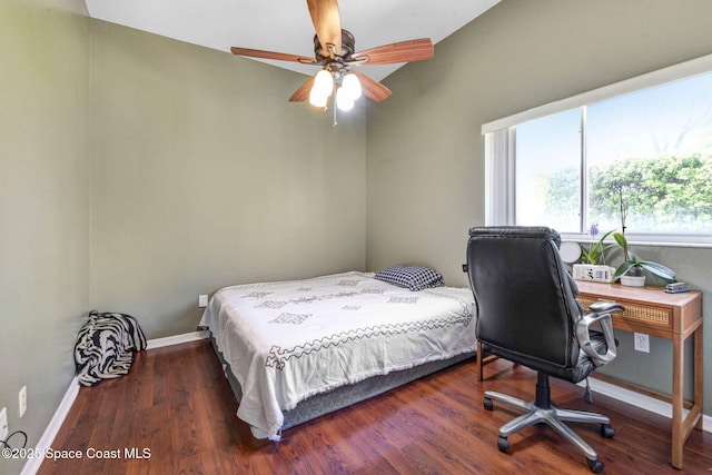 bedroom with wood finished floors, a ceiling fan, and baseboards