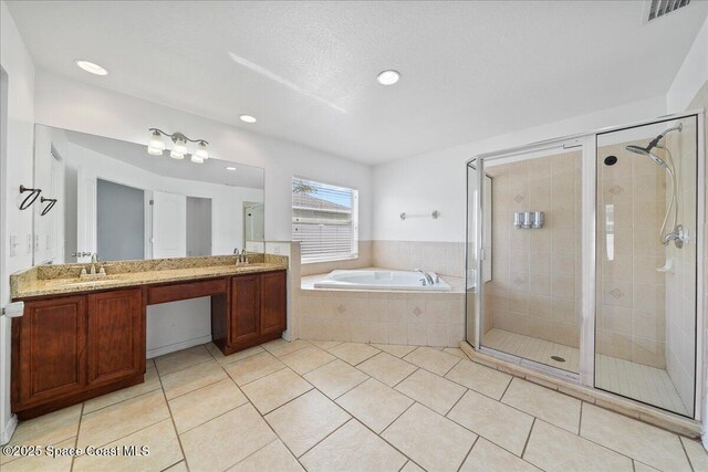 full bathroom with a stall shower, a bath, and tile patterned floors