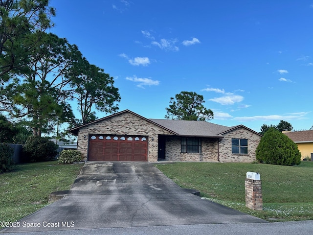 single story home featuring an attached garage, concrete driveway, brick siding, and a front yard