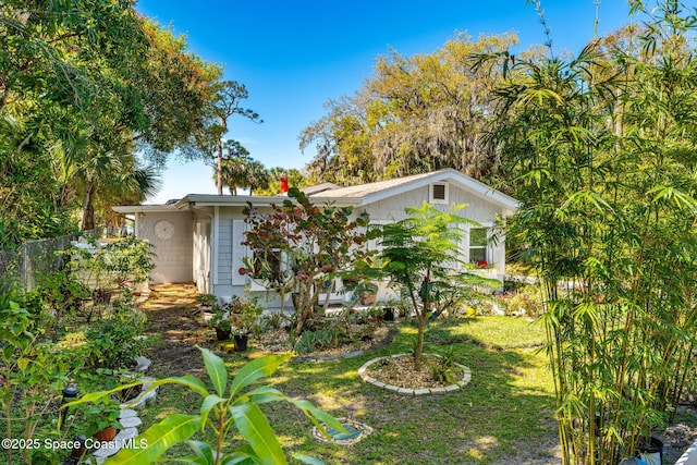 exterior space with fence and a front yard