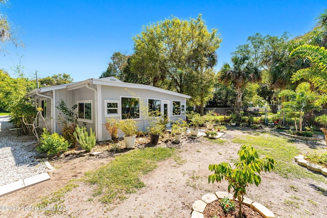 exterior space with fence and stucco siding