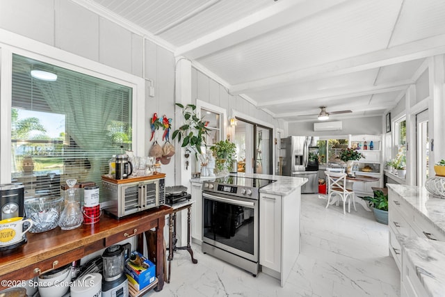 kitchen with marble finish floor, appliances with stainless steel finishes, white cabinets, and light stone countertops