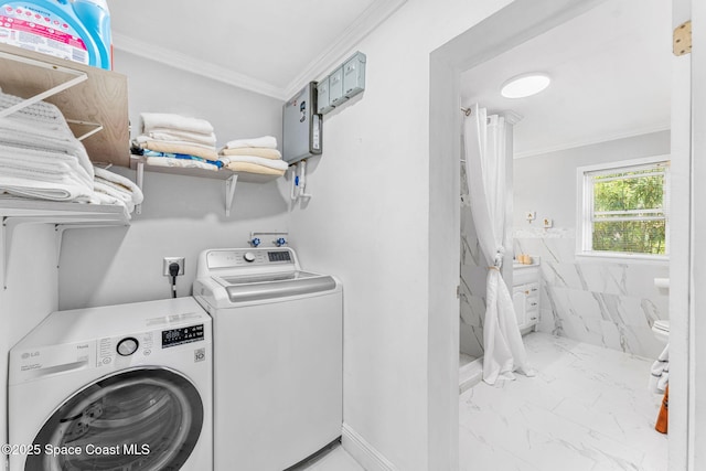 clothes washing area featuring laundry area, washing machine and dryer, marble finish floor, and crown molding