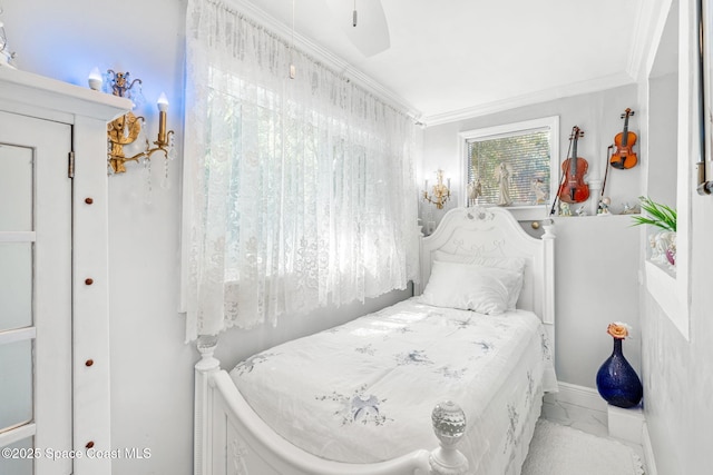 bedroom featuring marble finish floor and ornamental molding