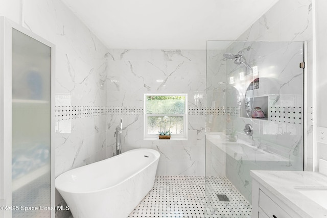 full bathroom featuring a soaking tub, a marble finish shower, vanity, and tile walls