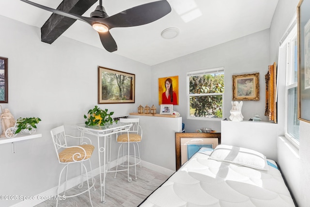 bedroom with a ceiling fan and baseboards