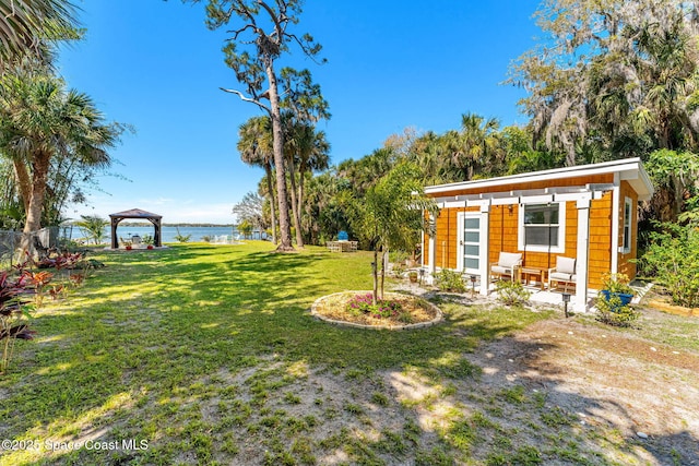 view of yard with a gazebo and a water view