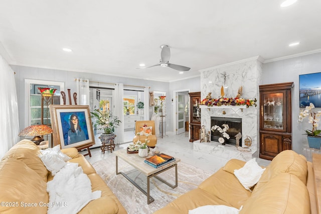 living area with marble finish floor, ornamental molding, a fireplace, and recessed lighting