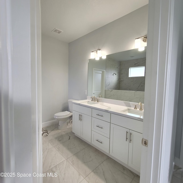 bathroom featuring toilet, marble finish floor, a sink, and visible vents