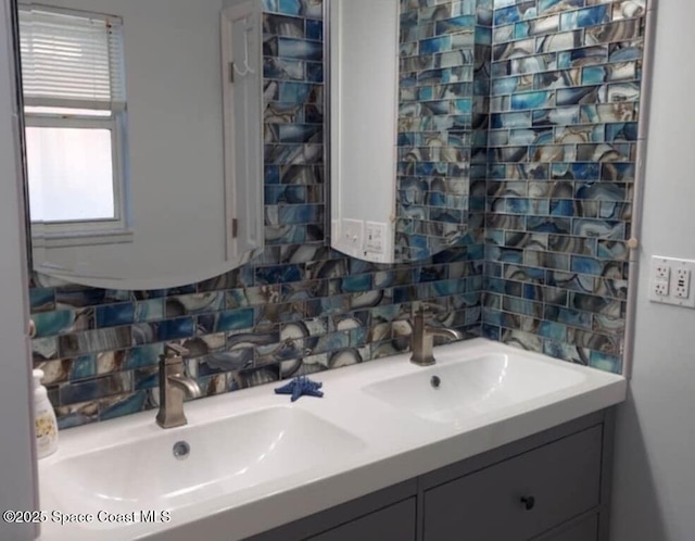 bathroom featuring double vanity, tasteful backsplash, and a sink