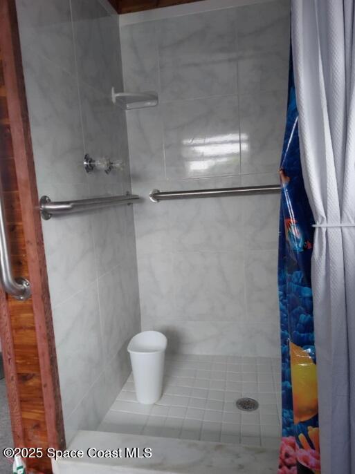 bathroom with tiled shower