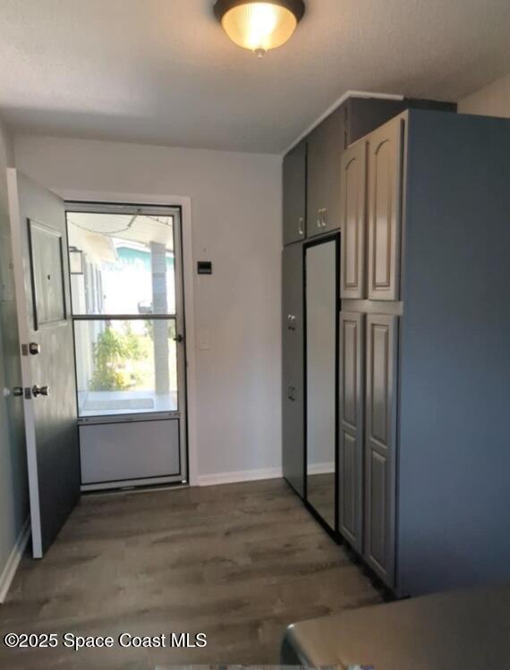 kitchen with baseboards and wood finished floors