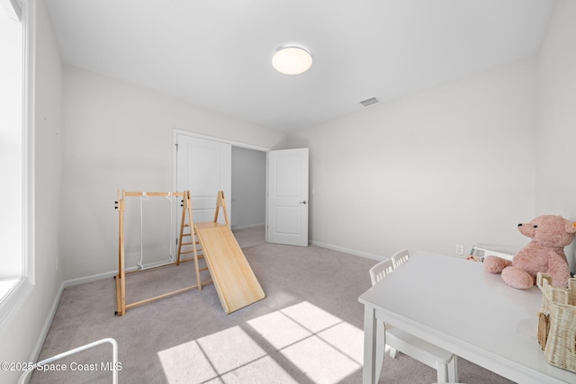 bedroom with carpet floors, visible vents, and baseboards