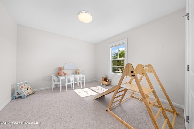 recreation room featuring carpet flooring and baseboards