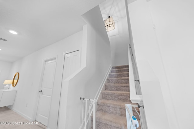 staircase with recessed lighting, visible vents, and baseboards