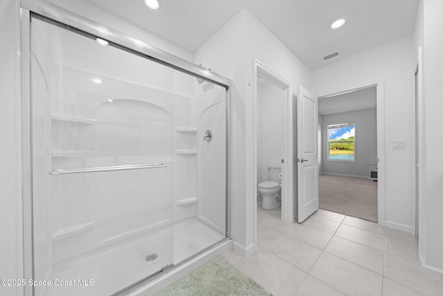 bathroom with toilet, a shower stall, visible vents, and tile patterned floors